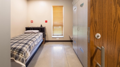 Fire station sleeping area with innovative space-saving rolling door design suggested by Miller Diversified in the design process to improve outcomes for client