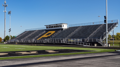 A football field with bleachers and pressbox by Miller Diversified