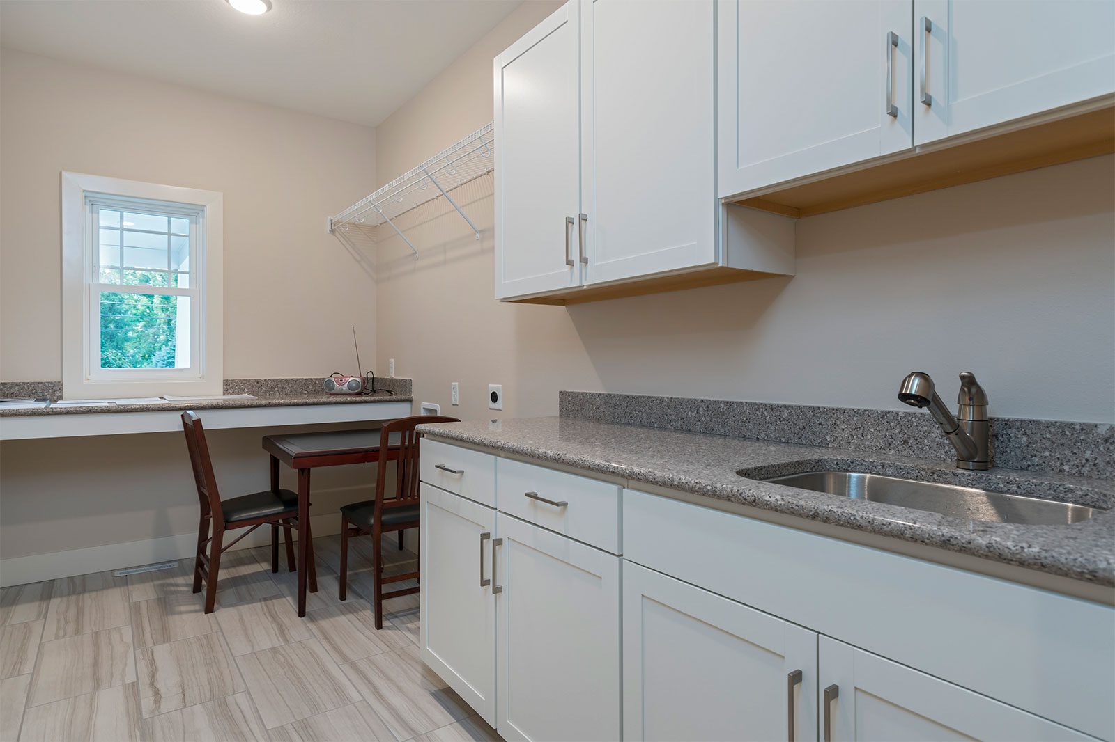 A spacious laundry room interior photo from a luxury home from the Villas at Blystone in Monclova, Ohio, constructed by the team at Miller Diversified